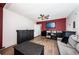 Cozy living room with wood-look flooring, modern furniture, and a large TV at 12901 129Th Ave, Largo, FL 33774