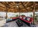 Relaxing outdoor living space featuring a thatched gazebo, comfortable seating, and stylish patio furniture at 12901 129Th Ave, Largo, FL 33774