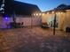 Inviting outdoor patio with string lights, dining table set, and comfortable seating area for evening relaxation at 12901 129Th Ave, Largo, FL 33774