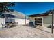 Paver patio with dining set, lounge seating and sliding glass doors to home at 12901 129Th Ave, Largo, FL 33774