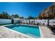 Backyard pool features a small shed, swing and playful decorations in a fenced yard at 12901 129Th Ave, Largo, FL 33774