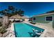 Lovely backyard pool with tiki hut, lounge area, and a shark float at 12901 129Th Ave, Largo, FL 33774