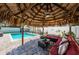 Beautiful backyard showcasing a sparkling pool, covered gazebo, and ample space for outdoor entertaining at 12901 129Th Ave, Largo, FL 33774