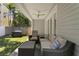 Relaxing covered patio with comfortable seating, ceiling fan, and views of the well-maintained backyard at 1008 S Armenia Ave # A, Tampa, FL 33629