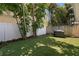 Lush backyard featuring an artificial lawn, privacy fence, and a gas grill perfect for outdoor cooking at 1008 S Armenia Ave # A, Tampa, FL 33629