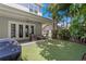 Backyard featuring covered patio, outdoor furniture, lush landscaping and artificial grass at 1008 S Armenia Ave # A, Tampa, FL 33629