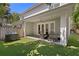 Expansive backyard with a covered patio, plush artificial lawn, and mature trees creating a private oasis at 1008 S Armenia Ave # A, Tampa, FL 33629
