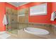 Bathroom featuring a separate shower and tub, and a window for natural light at 1008 S Armenia Ave # A, Tampa, FL 33629