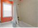 Cozy bathroom includes tiled walls, a shower-tub, and a window to let in natural light at 1008 S Armenia Ave # A, Tampa, FL 33629