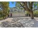Charming two-story home featuring a brick driveway and mature landscaping, including a large shade tree at 1008 S Armenia Ave # A, Tampa, FL 33629