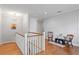 Upstairs hallway with hardwood floors, white railings, and neutral decor at 1008 S Armenia Ave # A, Tampa, FL 33629
