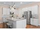 Modern kitchen features white cabinets, stainless steel appliances and a large center island with seating at 1008 S Armenia Ave # A, Tampa, FL 33629