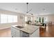 Open concept kitchen and dining area featuring stainless steel appliances, granite countertops and hardwood floors at 1008 S Armenia Ave # A, Tampa, FL 33629