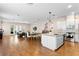 Open concept living room and kitchen area featuring stainless steel appliances, granite countertops and hardwood floors at 1008 S Armenia Ave # A, Tampa, FL 33629