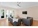 Bright living room featuring hardwood floors and French doors to the backyard at 1008 S Armenia Ave # A, Tampa, FL 33629