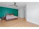 Spacious main bedroom with light wood floors, ceiling fan, and serene green accent wall at 1008 S Armenia Ave # A, Tampa, FL 33629