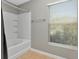Cozy bathroom featuring a shower-tub combination and a window for natural light at 10121 Westpark Preserve Blvd # 10121, Tampa, FL 33625