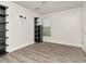 Neutral bedroom features wood floors, shelving unit, and a large window at 10121 Westpark Preserve Blvd # 10121, Tampa, FL 33625