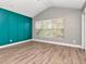 Bedroom features vaulted ceilings, accent wall, and a large window at 10121 Westpark Preserve Blvd # 10121, Tampa, FL 33625