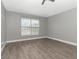 Bedroom with a ceiling fan, wood flooring, and a large window for natural light at 10121 Westpark Preserve Blvd # 10121, Tampa, FL 33625