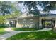 Community clubhouse with gated pool entrance, lush landscaping, and well-maintained exterior at 10121 Westpark Preserve Blvd # 10121, Tampa, FL 33625