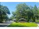Entrance to Westpark Preserve featuring a sign, landscaping, gate and mature trees offering a peaceful setting at 10121 Westpark Preserve Blvd # 10121, Tampa, FL 33625