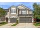 Charming two-story home featuring a two-car garage, well-manicured lawn, and classic architectural details at 10121 Westpark Preserve Blvd # 10121, Tampa, FL 33625