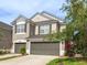 Two-story home featuring a well-maintained lawn, two-car garage, neutral paint, and decorative shutters at 10121 Westpark Preserve Blvd # 10121, Tampa, FL 33625