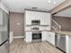Bright kitchen features white cabinets, stainless steel appliances, and granite countertops at 10121 Westpark Preserve Blvd # 10121, Tampa, FL 33625