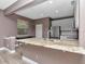 Open kitchen area with a granite countertop island, stainless steel appliances, and white cabinets at 10121 Westpark Preserve Blvd # 10121, Tampa, FL 33625