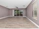 Spacious living room featuring sliding doors to the porch, ceiling fan, and wood-style flooring at 10121 Westpark Preserve Blvd # 10121, Tampa, FL 33625