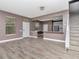 Open concept living room with wood floors, staircase, and view into kitchen area at 10121 Westpark Preserve Blvd # 10121, Tampa, FL 33625