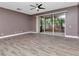 Large living room featuring sliding doors to the porch, ceiling fan, and wood-style flooring at 10121 Westpark Preserve Blvd # 10121, Tampa, FL 33625