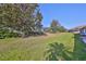 Expansive backyard with mature trees and lawn at 1016 Mcdaniel St, Sun City Center, FL 33573