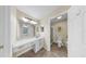 Bathroom featuring a vanity, a decorative mirror, and a glass shower with tile surround at 1016 Mcdaniel St, Sun City Center, FL 33573