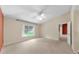 Bedroom featuring a window view, neutral paint, and carpet flooring, offering a comfortable living space at 1016 Mcdaniel St, Sun City Center, FL 33573