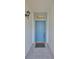 Charming entryway featuring a decorative window and a blue front door at 1016 Mcdaniel St, Sun City Center, FL 33573