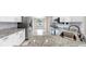 Bright kitchen with white cabinets, granite countertops, and stainless appliances at 1016 Mcdaniel St, Sun City Center, FL 33573