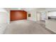 Open living area with neutral carpet, a vaulted ceiling, and view of the breakfast bar at 1016 Mcdaniel St, Sun City Center, FL 33573