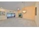 Large living room with vaulted ceilings, skylight, and elegant chandelier at 1016 Mcdaniel St, Sun City Center, FL 33573
