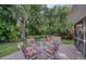 Charming backyard patio with seating amid lush, tropical landscaping at 10321 Shady Oak Ln, Seminole, FL 33777