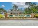 The Woods Community sign featuring lush landscaping and brick facade at 10321 Shady Oak Ln, Seminole, FL 33777