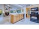 Kitchen view showcasing sink, cabinets and breakfast bar to living room at 10321 Shady Oak Ln, Seminole, FL 33777