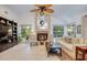 Comfortable living room featuring a fireplace with tile surround, large windows, and neutral decor at 10321 Shady Oak Ln, Seminole, FL 33777
