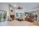 Bright living room features fireplace, seating and lots of natural light at 10321 Shady Oak Ln, Seminole, FL 33777