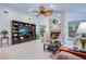 Bright living room features a ceiling fan, fireplace and built-in shelving at 10321 Shady Oak Ln, Seminole, FL 33777