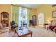Comfortable living room featuring neutral carpet, vaulted ceilings, and traditional decor throughout the space at 10321 Shady Oak Ln, Seminole, FL 33777