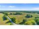 An aerial view of property featuring a long road, fencing and mature trees at 10614 Low Oak Terrace, Thonotosassa, FL 33592