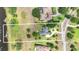 Aerial view of an estate surrounded by lush greenery, showcasing the spacious lot and serene waterfront property lines at 10614 Low Oak Terrace, Thonotosassa, FL 33592