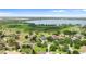 Beautiful aerial view of a luxury home in a lakeside community with mature landscaping at 10614 Low Oak Terrace, Thonotosassa, FL 33592